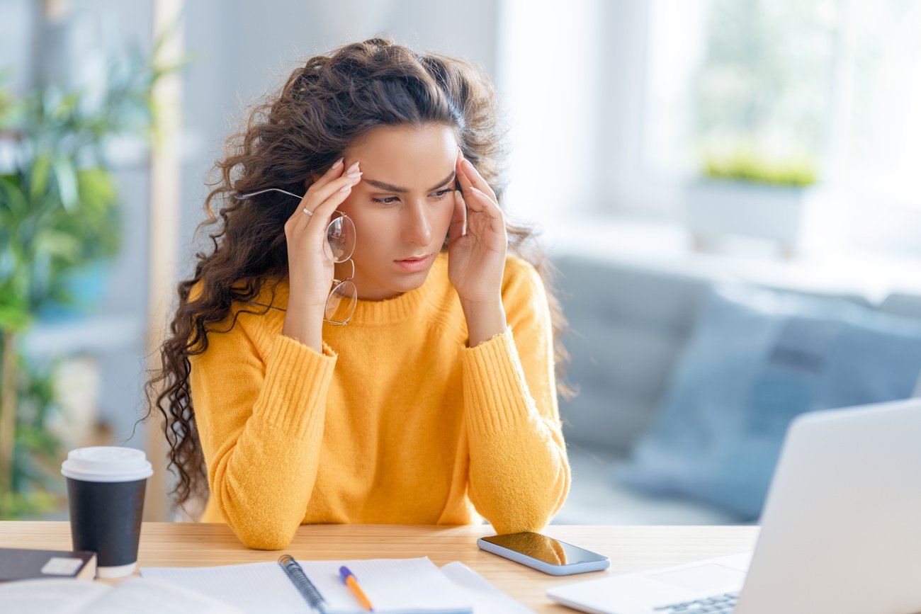 Young Woman Studying and Having a Head Ache