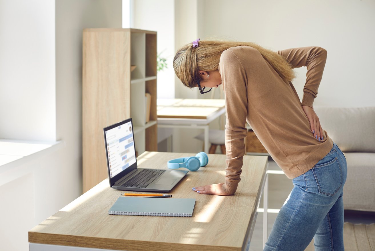 Woman Who Works in Sitting Posture on Her Computer All the Time Suffers from Back Pain